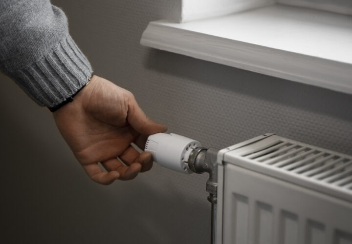 Man Turning Off Radiator Energy Crisis