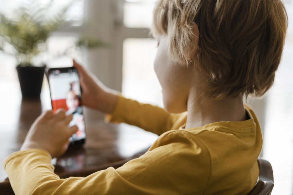 Side View Boy Using Smartphone Home