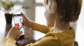 Side View Boy Using Smartphone Home