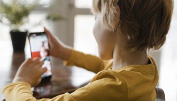 Side View Boy Using Smartphone Home